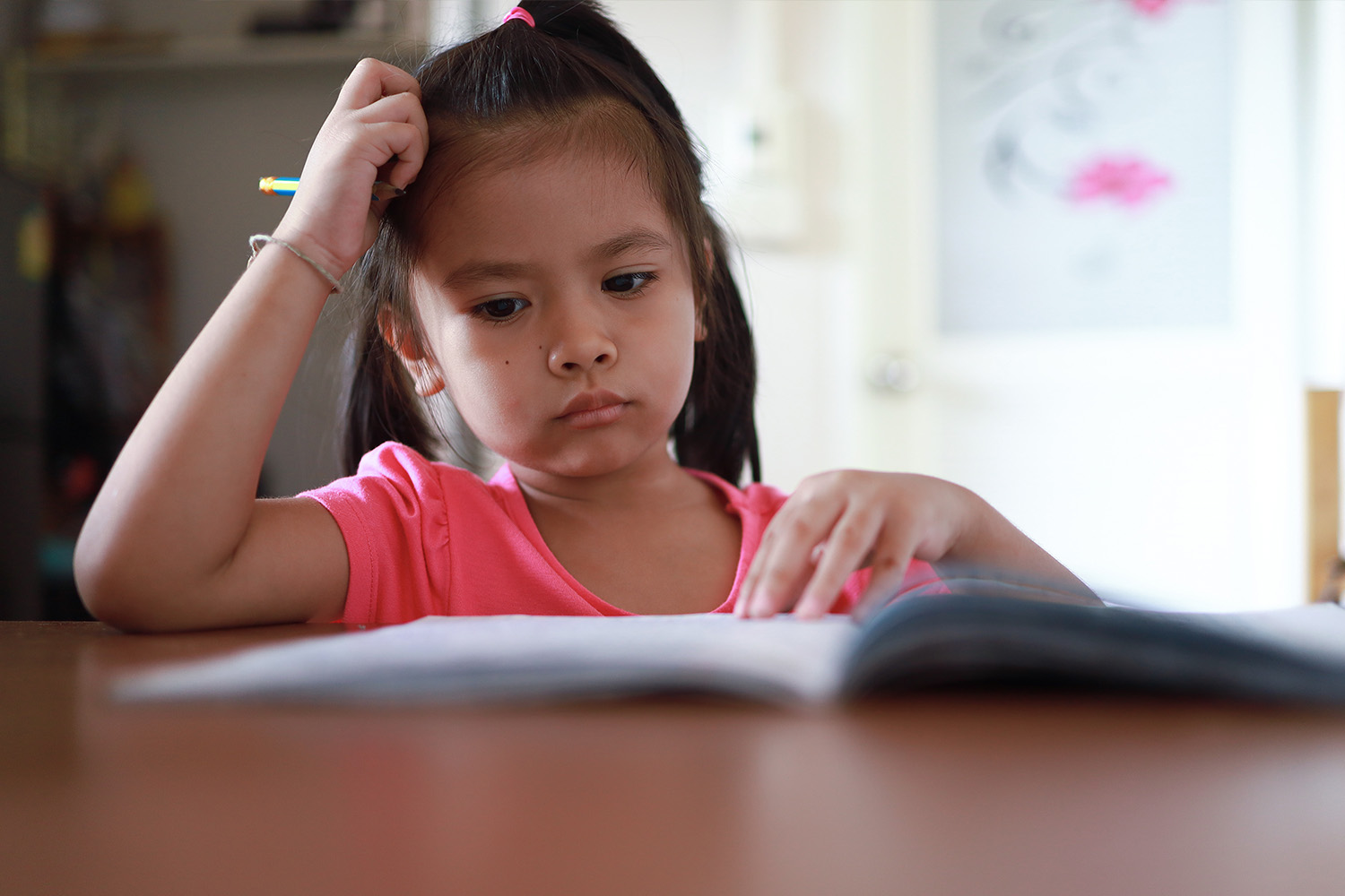 Young girl studying, showing how quality sleep enhances learning.