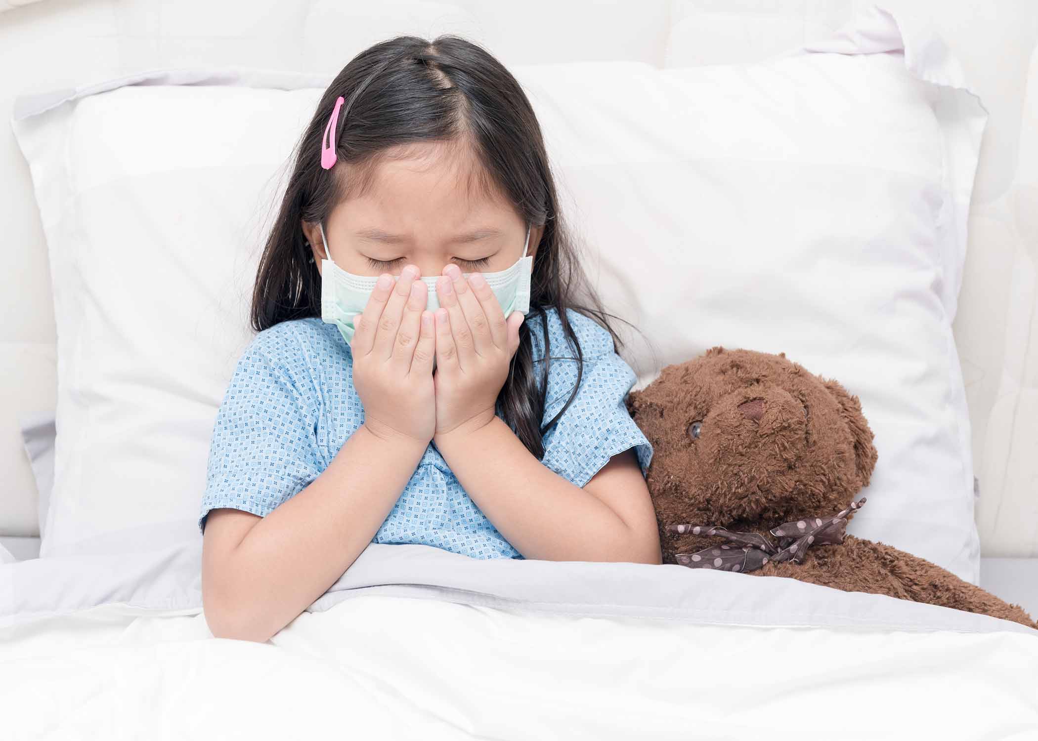 Child being examined by doctor for fever, flu, or stomach infection symptoms