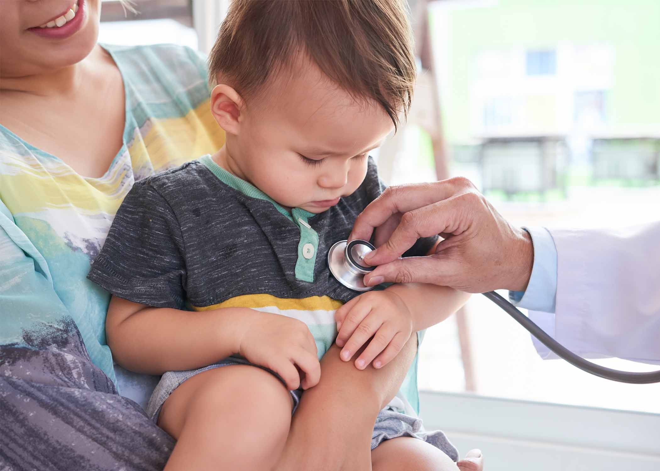 Pediatric cardiologist evaluating child’s heart condition using stethoscope and ECG