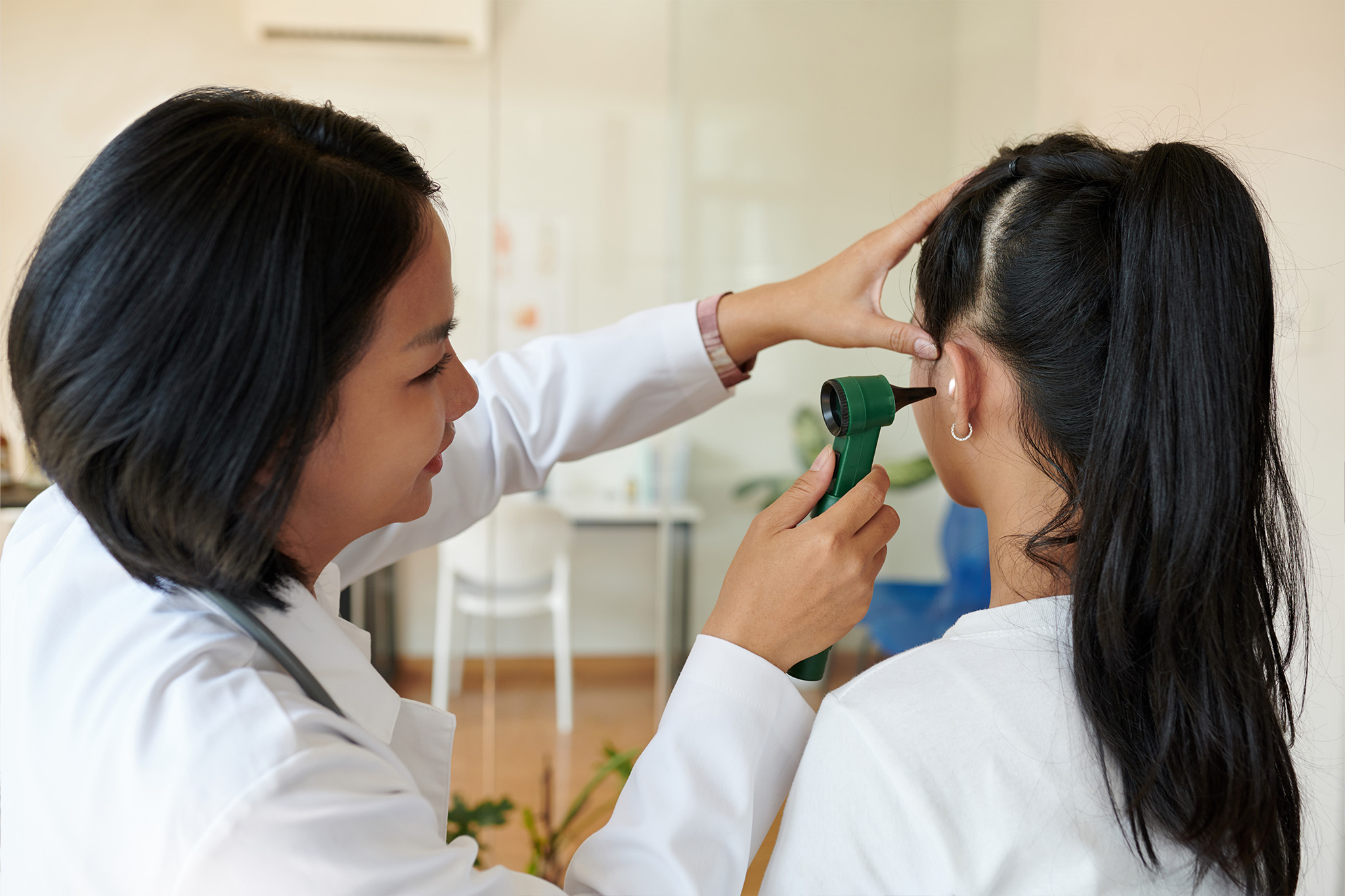 Child undergoing audiology hearing test with specialist for early hearing loss detection