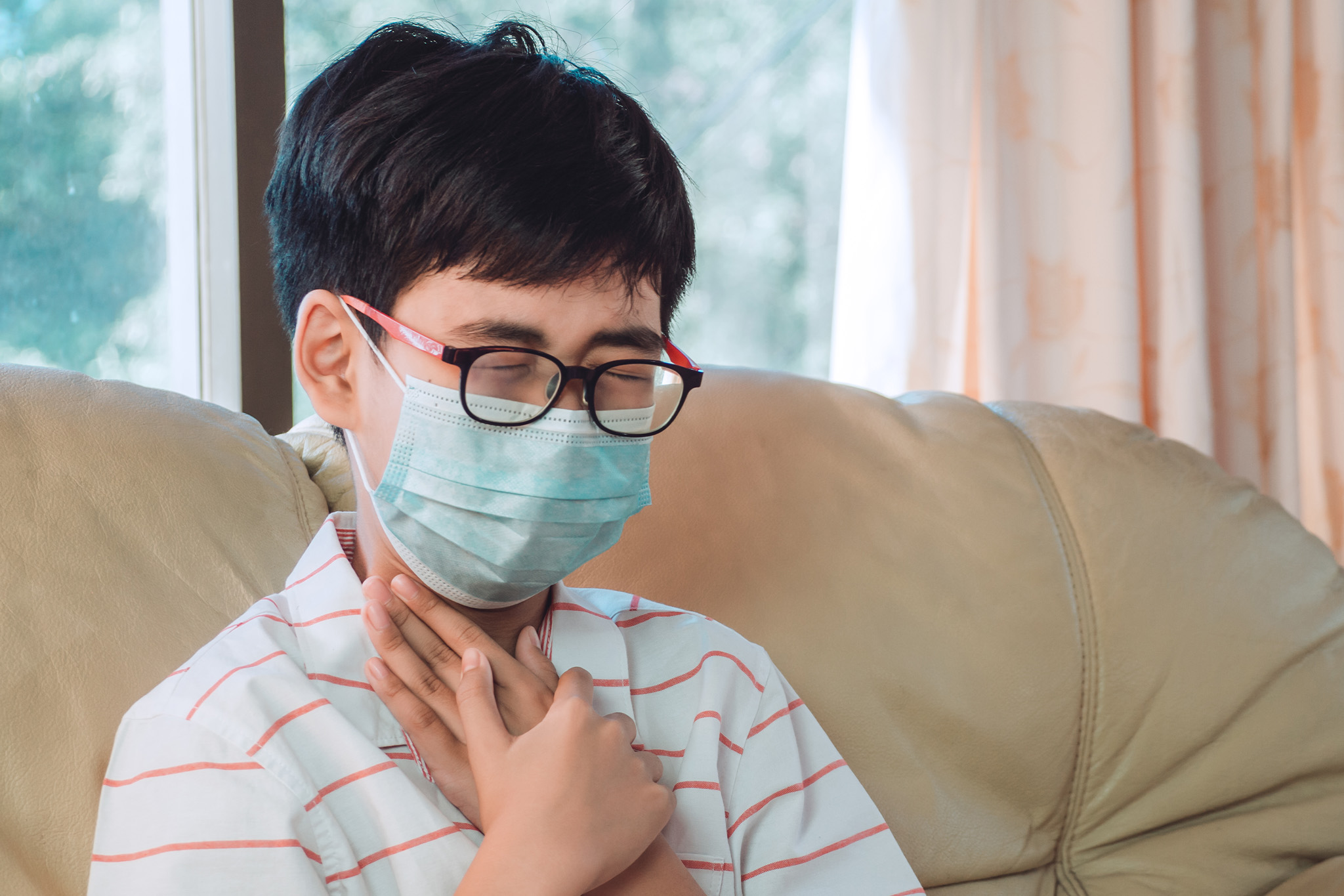Pediatric ENT specialist checking a child’s ear and throat for infection or blockage