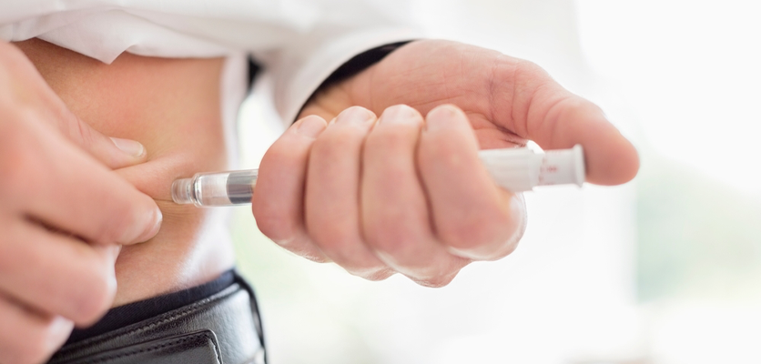 A person with diabetes using an insulin injection to manage blood sugar levels"