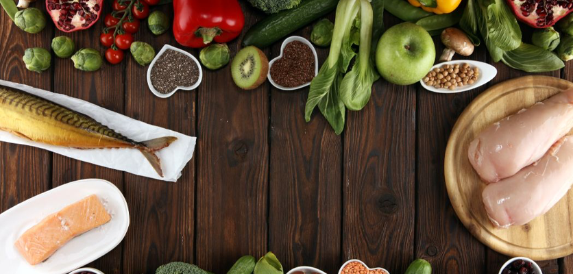 Assorted foods like salmon, mackerel, chicken, nuts, vegetables, and fruits rich in omega-3, magnesium, and zinc to support mental health and mood